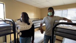 Najee Harris and his mother, Tianna Hicks, tour the room where his family of seven all lived at GRIP in Richmond. (Photo credit: GRIP)